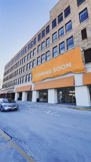 Orange Poster Rolls Down in fake-out-of-home ad of L'Oréal Paris