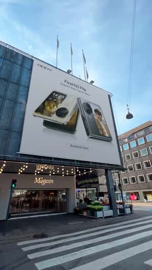 Flip Phone Burst Out From Billboard in fake-out-of-home ad of Oppo