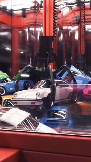Porsche 911 Claw Machine fake-out-of-home ad of Porsche