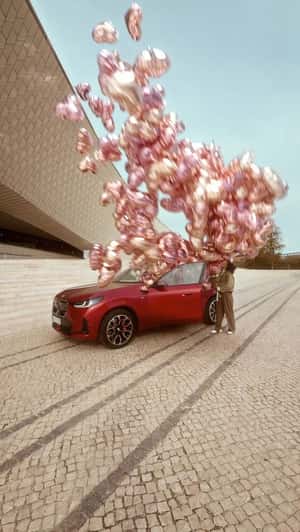 Red Car Releases Heart-shaped Balloons in fake-out-of-home ad of BMW