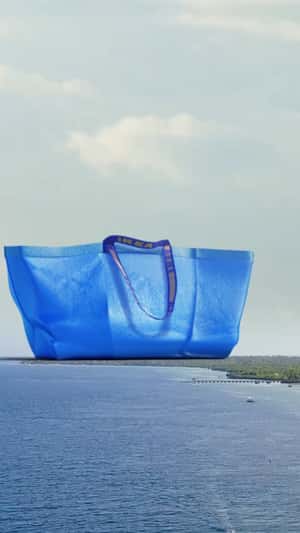 Blue Shopping Bag Rises Above the City in a fake-out-of-home ad of IKEA