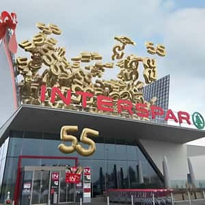 Roof Opens Releasing Golden 55 Balloons in a fake-out-of-home ad of Interspar