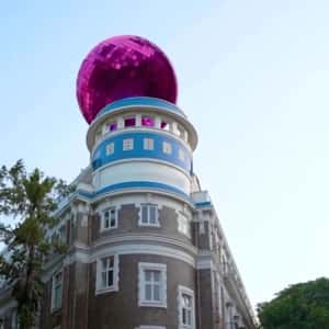 Pink Disco Ball Rolls Above the Building in a fake-out-of-home ad of Nykaa
