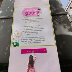 Massive Smartphone Leaning on a Building in a fake-out-of-home ad of Nykaa