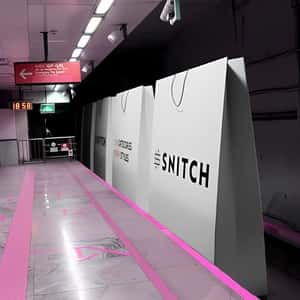 Shopping Bags Cruising Like Train in a fake-out-of-home ad of Snitch