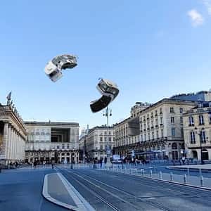 Buses Flying Above the City in a fake-out-of-home ad of Quoifaireabordeaux