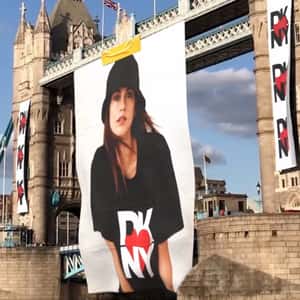 Model’s Poster Rolls Down on Bridge in a fake-out-of-home ad of DKNY