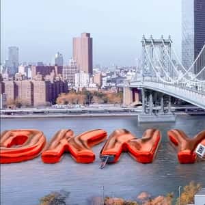 Inflatable Letters Float at the River in a fake-out-of-home ad of DKNY