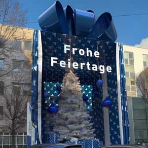 Building Gift Box Reveals Christmas Tree in a fake-out-of-home ad of Volksbank