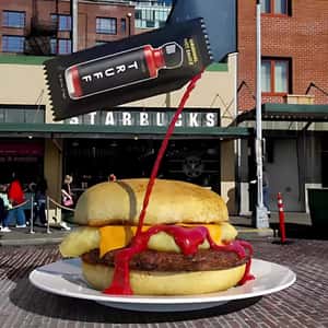 Sachet Pours Hot Sauce on Sandwich in a fake-out-of-home ad of TRUFF