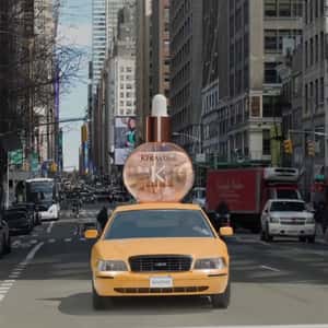 Oil Drops Bottle Rides Above the Taxi in a fake-out-of-home ad of Kérastase