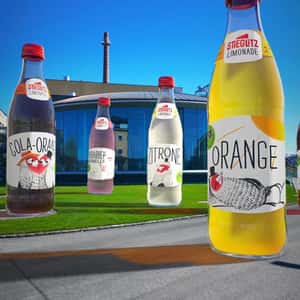 Soda Bottles Standing Near Brewery in a fake-out-of-home ad of Stieglitz Limonade