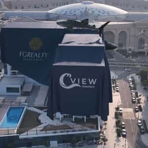 Living Whales Floating on Covered Building in a fake-out-of-home ad of Qatar Living Properties