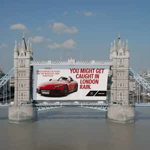 Poster Rolls Down at Bridge in London in a fake-out-of-home ad of Mercedes
