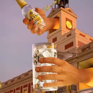 Hands Pouring a Drink at Building in a fake-out-of-home ad of Royal Bliss