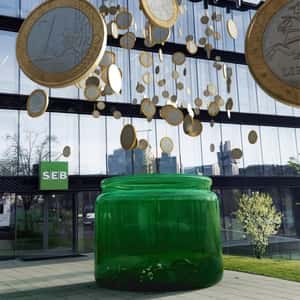 Coins On Thread Hangs Above A Jar in a fake-out-of-home ad of SEB