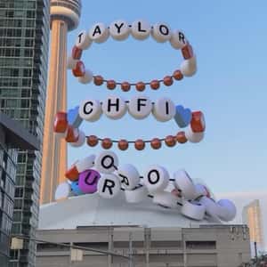Letter Bead Bracelets Drop on Stadium in a fake-out-of-home ad of 98.1 CHFI