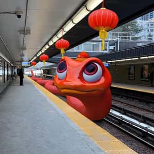 Red Snake Slithers on Train Station in a fake-out-of-home ad of Toronto Transit Commission