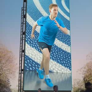 Runner Comes Out From Billboard in a fake-out-of-home ad of Under Armour