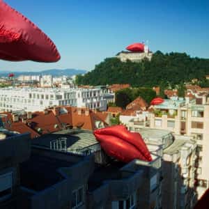 Inflatable Red Lips Resting Above Castle in a fake-out-of-home ad of Smile