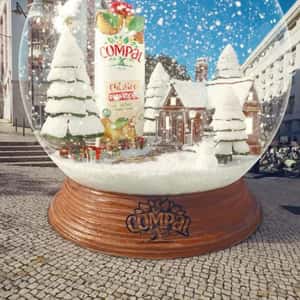 Juice Pack Stands Inside Snow Globe in a fake-out-of-home ad of Compal