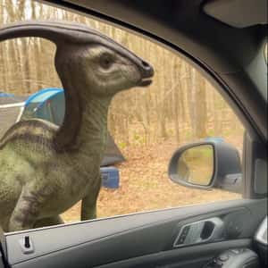 Dinosaurs Appear in Front of the Car in a fake-out-of-home ad of Netflix
