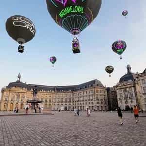 Hot Air Balloons Glide Above Paris in a fake-out-of-home ad of Madame Loyal Festival