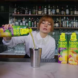 Fruits Emerge from Cup to City in a fake-out-of-home ad of Rauch Happy Day