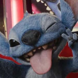 Stitch Grabs Phone from Woman in a fake-out-of-home ad of Disney Studios