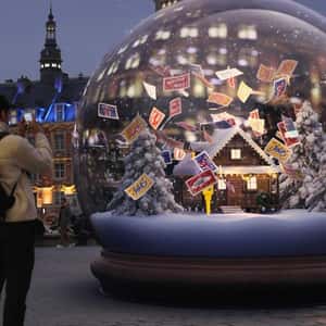 Post Stamps Floating Inside Snow Globe in a fake-out-of-home ad of La Poste