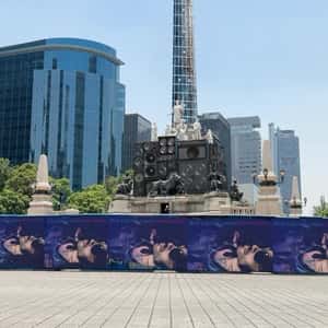 Electric Guitar Hangs on Angel Statue in a fake-out-of-home ad of Lenny Kravitz