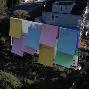 Billboards Covered with Stick Notes in a fake-out-of-home ad of Figma
