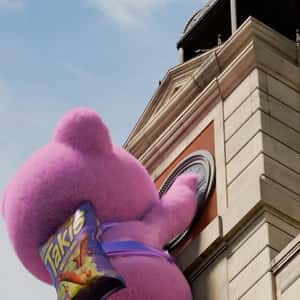 Teddy Bear Climbs at Clock  Tower in a fake-out-of-home ad of Takis