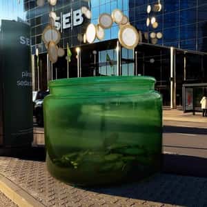 Hanging Coins Fell on Green Jar in a fake-out-of-home ad of SEB