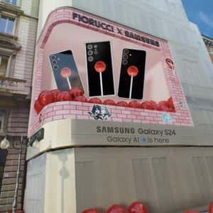 Lollipop and Phone Emerge on Digital Screen in a fake-out-of-home ad of Samsung