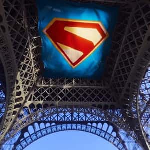 Logo on Banner Attach Under Eiffel Tower in a fake-out-of-home ad of Superman