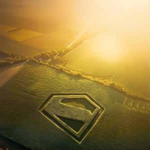 Logo Formed on Green Field in a fake-out-of-home ad of Superman
