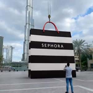 Crane Lowers Down Shopping Bag in a fake-out-of-home ad of Sephora
