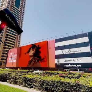 Hair Dryer Emerges Behind Billboard in a fake-out-of-home ad of Sephora