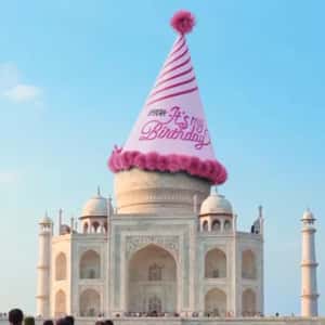 Landmarks Wearing Party Hats in a fake-out-of-home ad of Nykaa