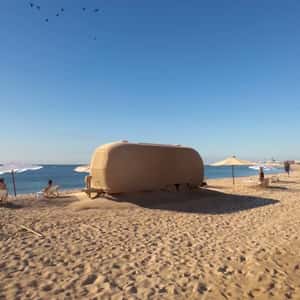 Sand-covered Trailer on Beach in a fake-out-of-home ad of Maisons du Monde