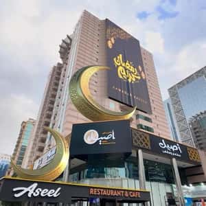 Golden Crescent Moons at Cafe in a fake-out-of-home ad of Aseel Restaurant