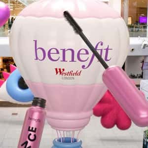 Hot Air Mascara Emerges from Hot Air Balloon in a fake-out-of-home ad of Benefit Cosmetics
