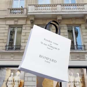 Shopping Bags Emerges from Store in a fake-out-of-home ad of Bompard