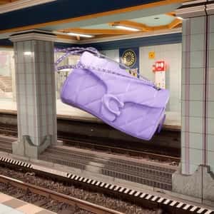 Shoulder Bag Floats Above Railway in a fake-out-of-home ad of Coach