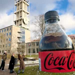 Plastic Bottle Emerges from the Ground in a fake-out-of-home ad of Coca-Cola