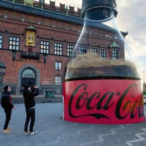 Ground Trembles as Bottle Emerges in a fake-out-of-home ad of Coca-Cola
