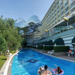 Silver Dolphin Glides Above the Pool in a fake-out-of-home ad of Delphin Hotels