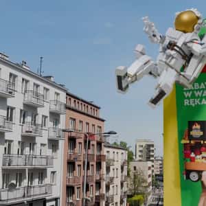 Astronaut Grabbed by Hand from Billboard in a fake-out-of-home ad of LEGO