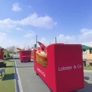 Bucket on Wheels Filled with Lobsters in a fake-out-of-home ad of Lobster & Co